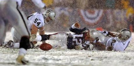 Color Daily -- Foxboro-1/19/2002- Pats vs. Oakland Patriots quarterback Tom Brady loses athe ball after being hit by the Raiders Charles Woodson (right) the fumble was recovered by Greg Biekert (54), but it was ruled an incomplete pass, giving the Patriots another chance. -- Library Tag 01202002 Playoff Extra PLAYOFF EXTRA

